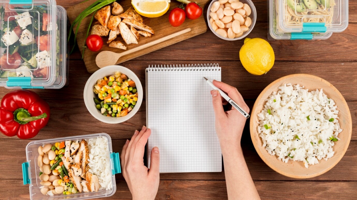 hands-writing-notebook-with-casseroles-ad-food_23-2148487771