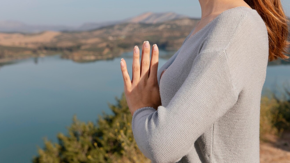 side-view-woman-meditating-nature_23-2148940308
